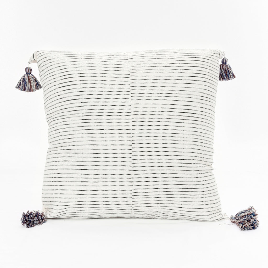 Throw pillow by Ginger Sparrow, a modern handcrafted home decor brand. Featuring a rich cream base with ticking stripes in black. Finished with fluffy cotton tassels for some extra lush. 