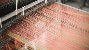 The wevaing loom setup with threads, ready to weave the spring textile collection for Ginger Sparrow, a modern handcrafted home decor brand. 
