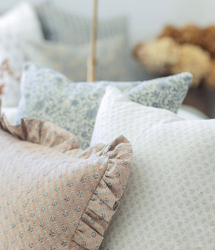 Patterned cushions on a sofa with a blurred background