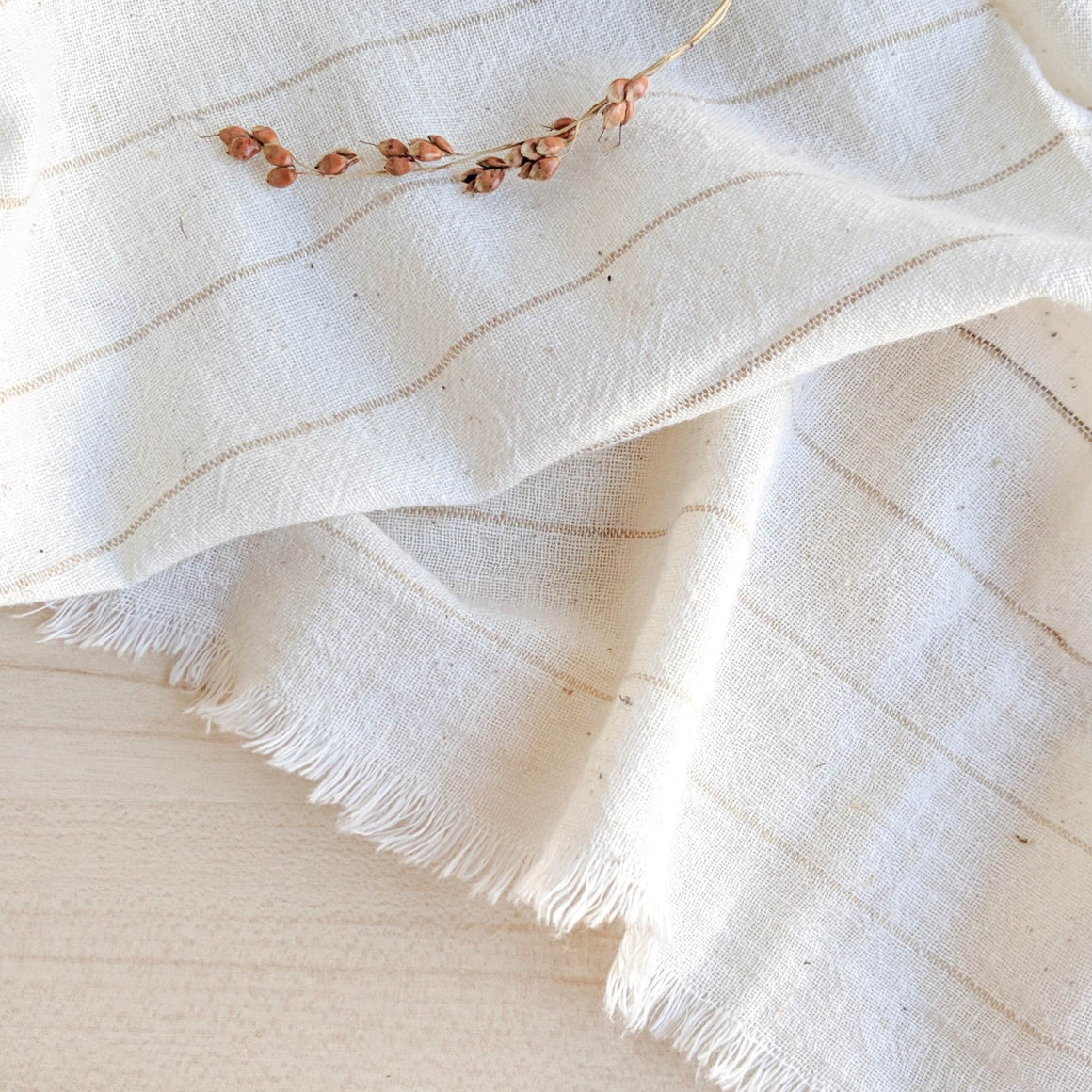 Handwoven Textile by Ginger Sparrow, a modern home decor brand. Featuring a soft ivory ground with fawn colored striped weave. Light and airy its perfect for #windowshades #drapes #livingroomdecor #bedroomideas