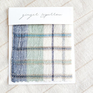 Handwoven Textile by Ginger Sparrow, a modern home decor brand. Featuring a soft ivory ground with a green and indigo striped weave. Light and airy its perfect for #windowshades #drapes #livingroomdecor #bedroomideas