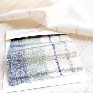 Handwoven Textile by Ginger Sparrow, a modern home decor brand. Featuring a soft ivory ground with a green and indigo striped weave. Light and airy its perfect for #windowshades #drapes #livingroomdecor #bedroomideas