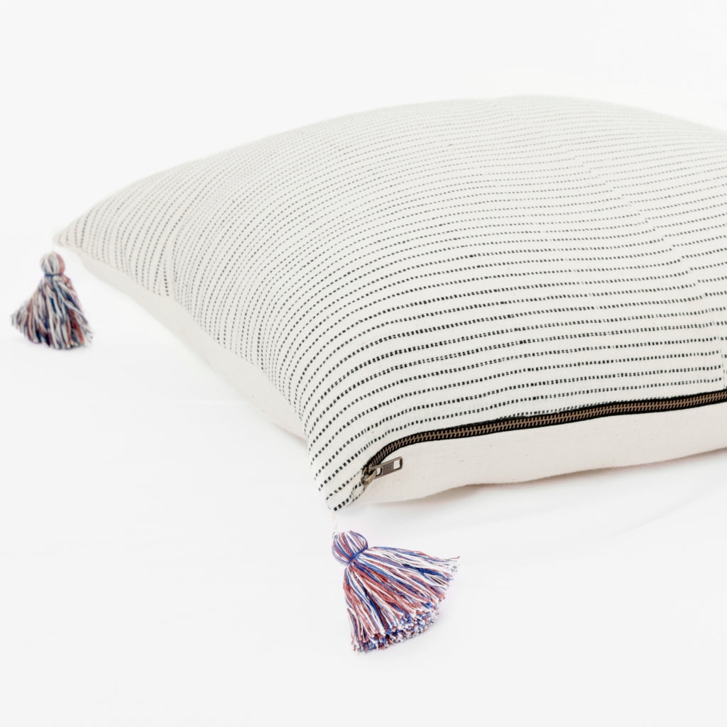 Throw pillow by Ginger Sparrow, a modern handcrafted home decor brand. Featuring a rich cream base with ticking stripes in black. Finished with fluffy cotton tassels for some extra lush. 