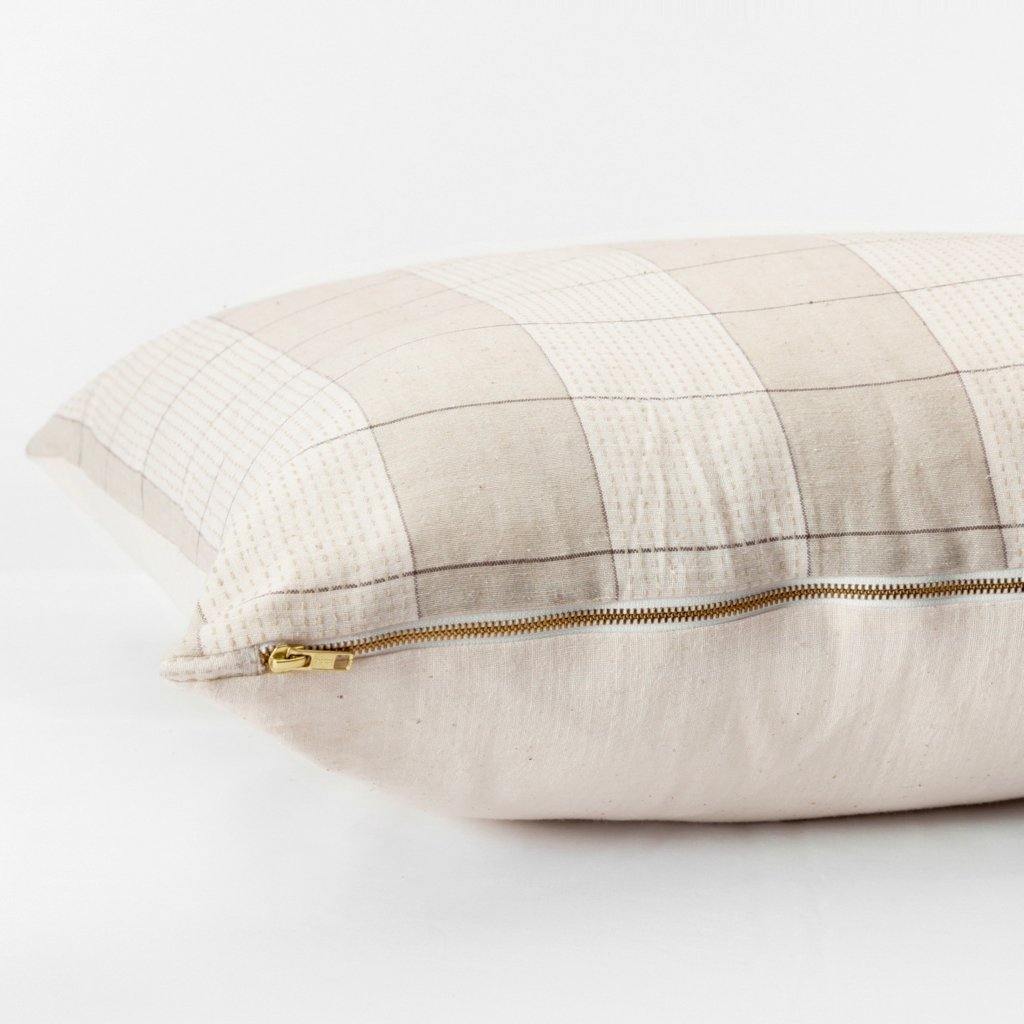Throw pillow by Ginger Sparrow, a modern handcrafted home decor brand. The pillow features a soft ivory and dusty sage base with air geometric lines in a grid pattern. 