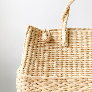 Watergrass Hamper Baskets in a light buttery golden hue. Handcrafted in 3 nesting sizes, great as a picnic hamper baskets. Crafted by Ginger Sparrow, a modern home decor brand. 