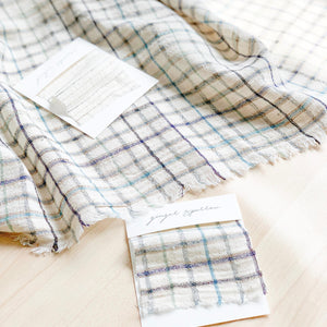 Handwoven Textile by Ginger Sparrow, a modern home decor brand. Featuring a soft ivory ground with a green and indigo striped weave. Light and airy its perfect for #windowshades #drapes #livingroomdecor #bedroomideas
