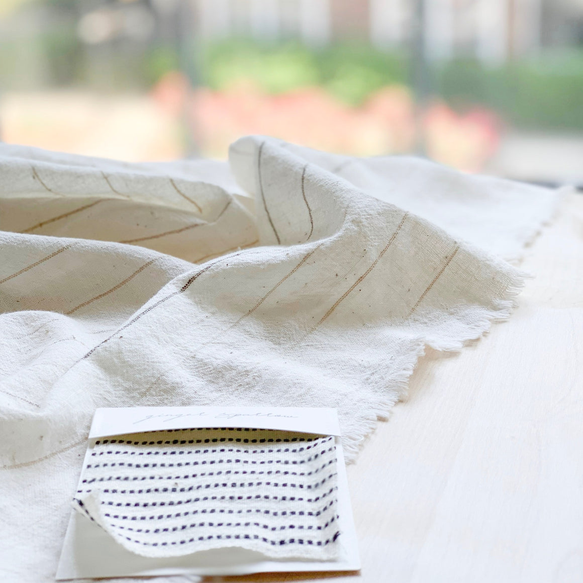 Handwoven Textile by Ginger Sparrow, a modern home decor brand. Featuring black ticking stripes on a soft ivory ground. Light and airy its perfect for #throwpillows #drapes #livingroomdecor #bedroomideas