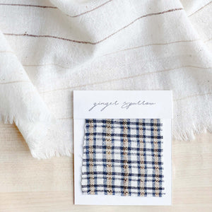 Handwoven Textile by Ginger Sparrow, a modern home decor brand. Featuring a fawn and indigo checkered weave. Light and airy its perfect for #throwpillows #drapes #livingroomdecor #bedroomideas