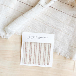 Handwoven cotton textile by Ginger Sparrow, a modern home decor brand. Featuring rugged stripes in earthy terracotta on a soft ivory ground. Light and airy its perfect for #throwpillows #drapes #livingroomdecor #bedroomideas