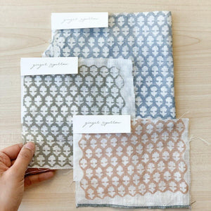 Hand block printed Textile by Ginger Sparrow, a modern home decor brand. Featuring a delicate floral pattern in three color options - olive grey, tan and pale blue. Light and airy its perfect for #throwpillows #drapes #livingroomdecor #bedroomideas #upholsteryfabric #fabricbytheyard