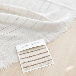 Handwoven Textile by Ginger Sparrow, a modern home decor brand. Featuring a brown thick stripe woven on a soft ivory ground. Light and airy its perfect for #throwpillows #drapes #livingroomdecor #bedroomideas