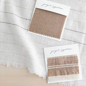 Handwoven Textile by Ginger Sparrow, a modern home decor brand. Featuring a brown thick stripe woven on a soft ivory ground. Light and airy its perfect for #throwpillows #drapes #livingroomdecor #bedroomideas