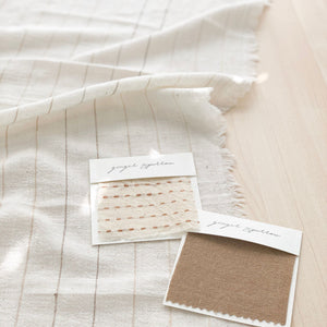 Handwoven Textile by Ginger Sparrow, a modern home decor brand. Featuring a brown ticking stripe woven on a soft ivory ground. Light and airy its perfect for #throwpillows #drapes #livingroomdecor #bedroomideas