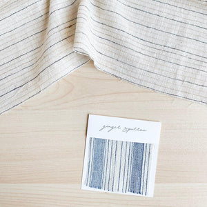 Handwoven Textile by Ginger Sparrow, a modern home decor brand. Featuring a blue thick stripe woven, light and airy its perfect for #throwpillows #drapes #livingroomdecor #bedroomideas