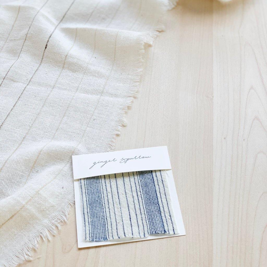 Handwoven Textile by Ginger Sparrow, a modern home decor brand. Featuring a blue thick stripe woven, light and airy its perfect for #throwpillows #drapes #livingroomdecor #bedroomideas