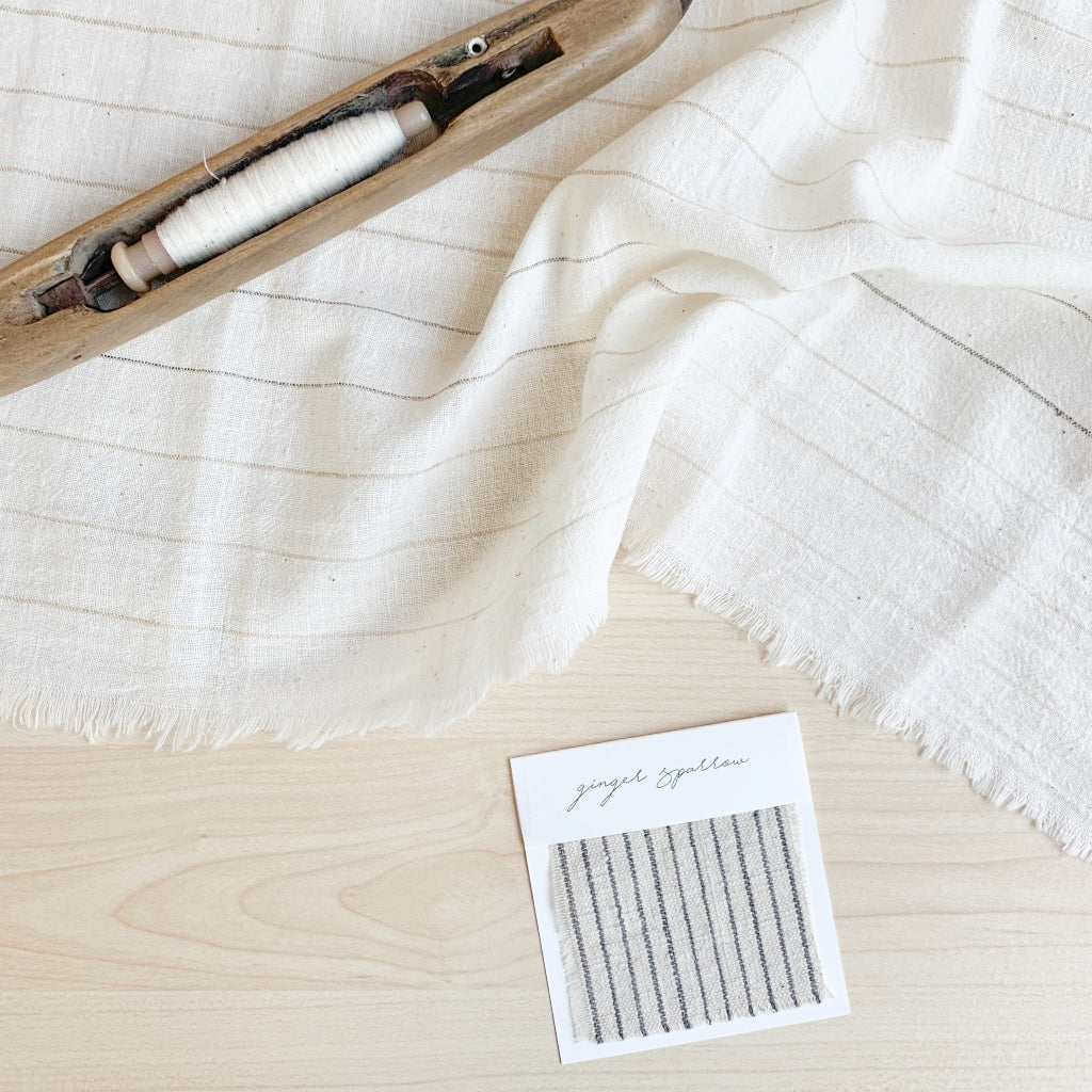 Handwoven Textile by Ginger Sparrow, a modern home decor brand. Featuring a charcoal black stripe pattern woven on a soft ivory ground. Light and airy its perfect for #throwpillows #drapes #livingroomdecor #bedroomideas