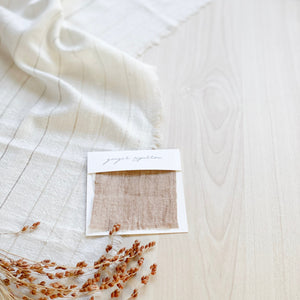 Handwoven Textile by Ginger Sparrow, a modern home decor brand. Featuring a brown thick stripe woven on a soft ivory ground. Light and airy its perfect for #throwpillows #drapes #livingroomdecor #bedroomideas