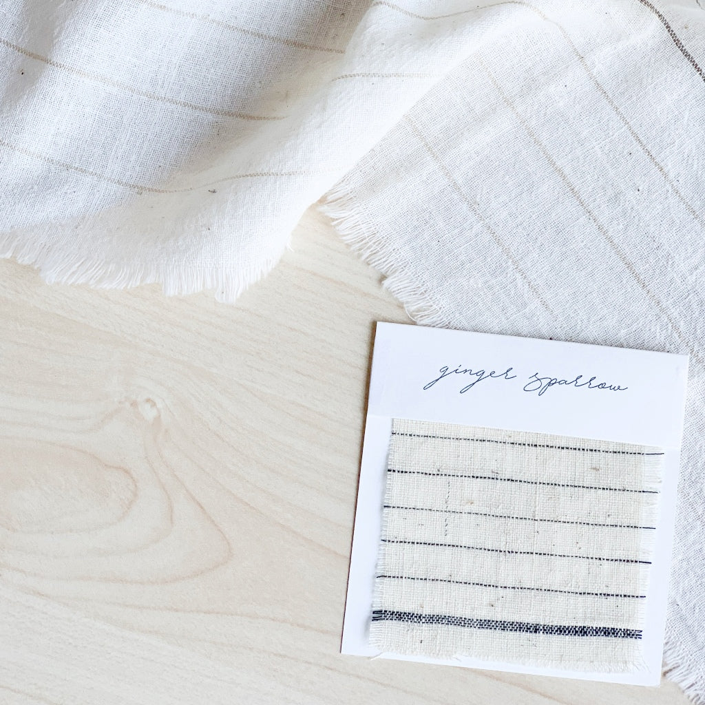 Handwoven Textile by Ginger Sparrow, a modern home decor brand. Featuring a charcoal black stripe pattern woven on a soft ivory ground. Light and airy its perfect for #throwpillows #drapes #livingroomdecor #bedroomideas