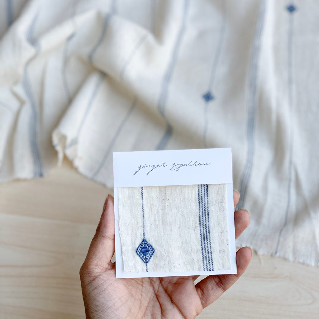 Handwoven Textile by Ginger Sparrow, a modern home decor brand. Featuring a blue diamond pattern woven, light and airy its perfect for #throwpillows #drapes #livingroomdecor #bedroomideas