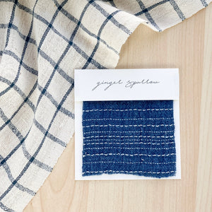 Handwoven Textile by Ginger Sparrow, a modern home decor brand. Featuring an indigo base witha  striped patternLight and airy its perfect for #throwpillows #drapes #livingroomdecor #bedroomideas