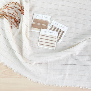 Handwoven Textile by Ginger Sparrow, a modern home decor brand. Featuring a brown thick stripe woven on a soft ivory ground. Light and airy its perfect for #throwpillows #drapes #livingroomdecor #bedroomideas
