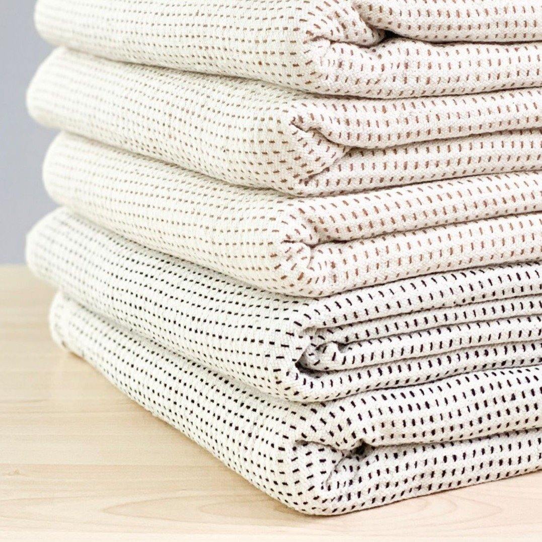 A soft ivory and brown striped handwoven cotton pillow . Handcrafted by Ginger Sparrow, a modern home decor brand.
