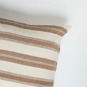 A soft ivory and brown striped handwoven cotton pillow . Handcrafted by Ginger Sparrow, a modern home decor brand.
