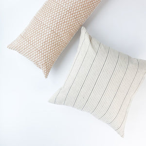 A soft ivory pillow featuring a charcoal striped pattern. Handcrafted by Ginger Sparrow, a modern home decor brand.